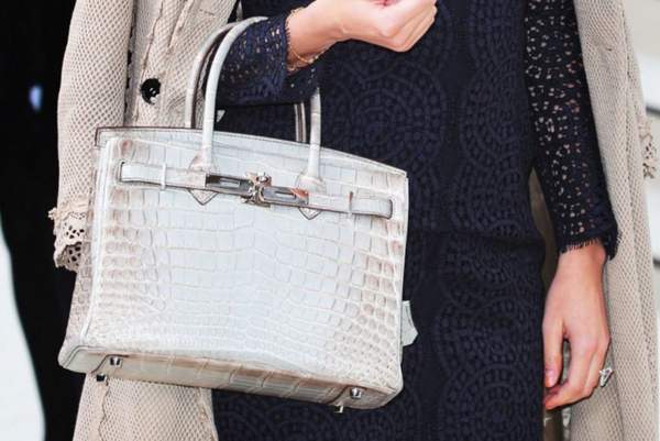 une femme tenant un sac Hermès Birkin